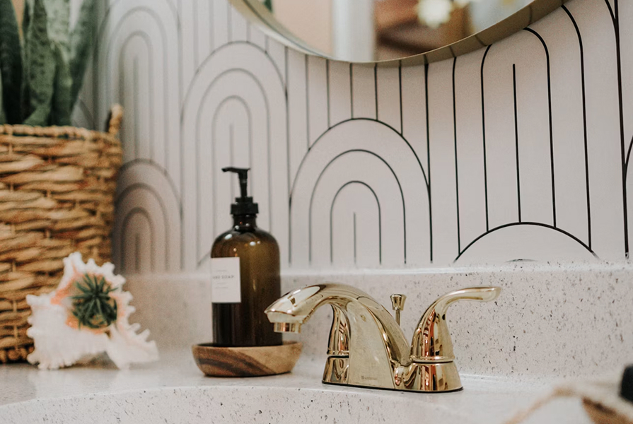 A soap dispenser beside a bathroom basin